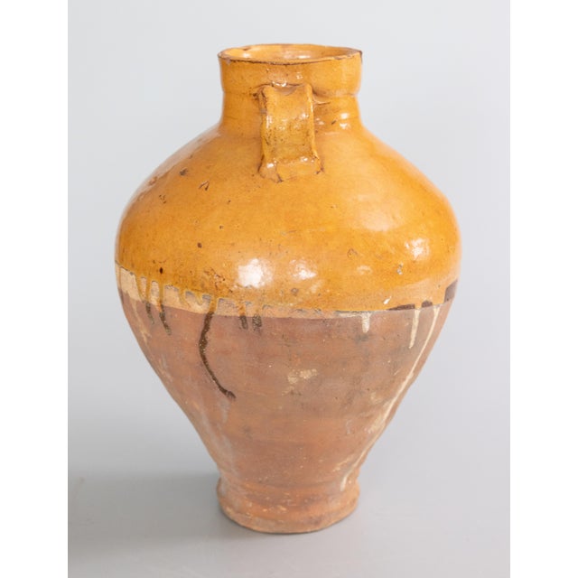 A superb 19th century French olive jar or urn with a lovely drippy mustard yellow glaze. This pot is hand thrown with a...