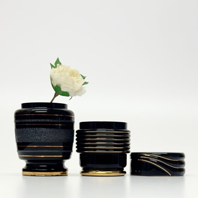 Black and gold ceramic vessels, group of 3. A classic and regal assortment of art deco revival black and gold ceramic...