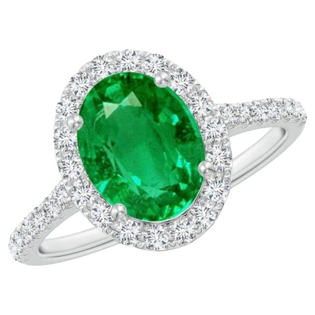 Introducing a truly stunning piece, behold the 2.5 Carat Oval Natural Zambian Emerald & 1.25 ct Diamond Ring in exquisite...