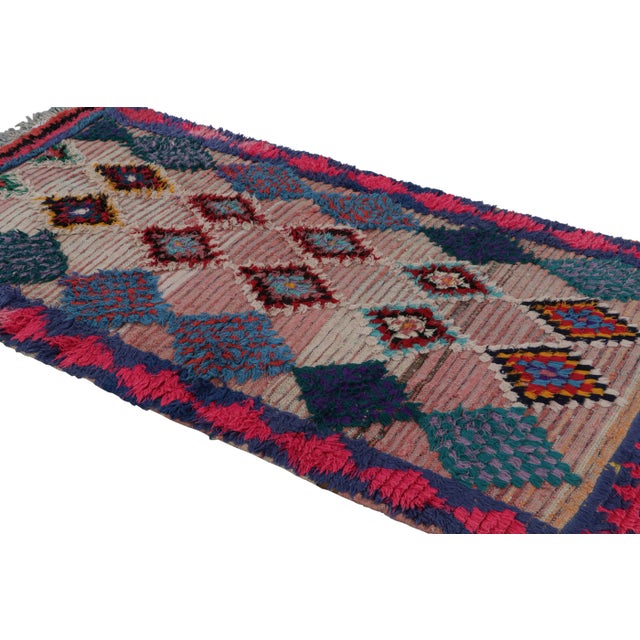 Hand-knotted in wool circa 1950-1960, this vintage 4x8 Moroccan rug is believed to hail from the Azilal tribe. On the...