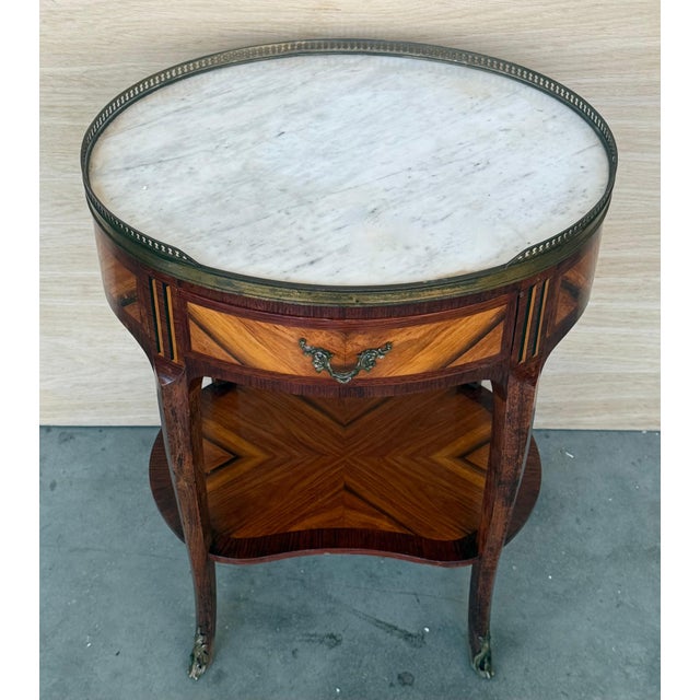 A French Louis XVI style neoclassical nightstand, with a pierced brass gallery and Bianco Carrara marble top, drawer and...