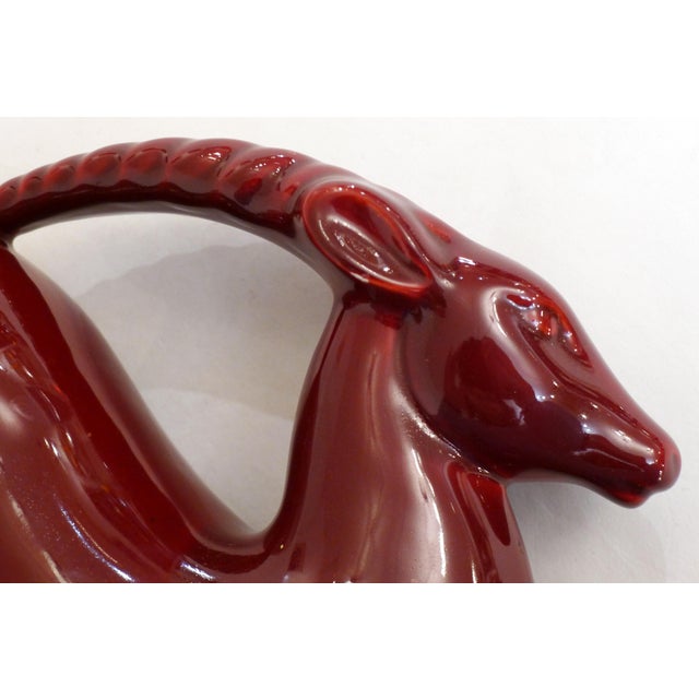 Large Art Deco sculpture of galloping gazelle / antelope, stylized representation on double base with vegetation / tall...