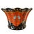 A striking ceramic cachepot featuring a bold terracotta and black color palette and intricate neoclassical motifs,...