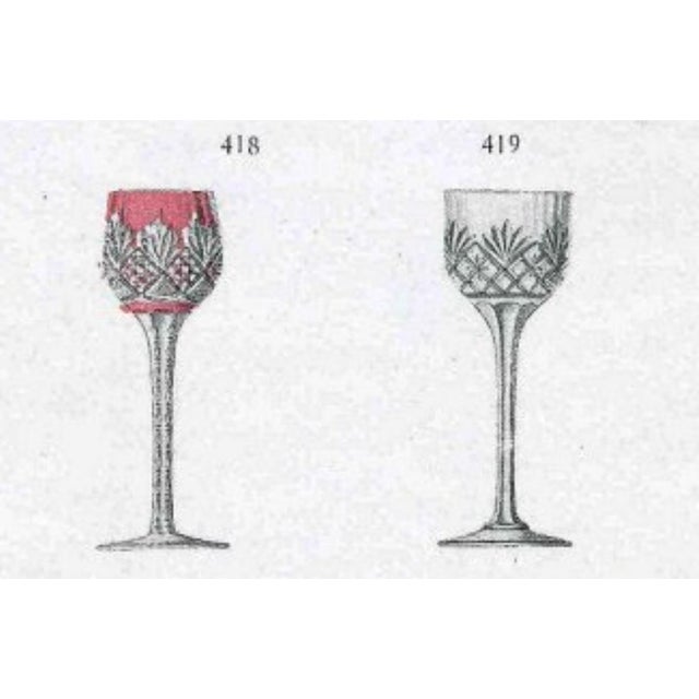 An exceptional and elegant set of 9 liquor glasses from the prestigious French crystal house Saint-Louis, crafted in the...