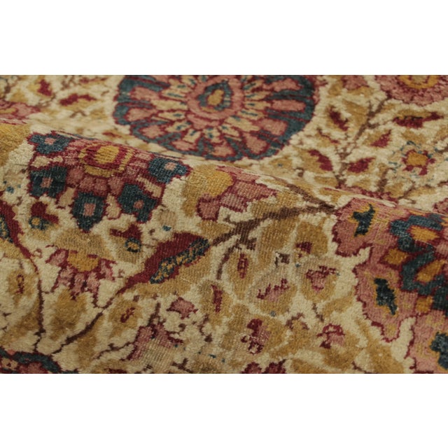 Hand-knotted in wool and originating from Persia circa 1910-1920, this 8x10 antique Persian Kashan area rug is a rare...