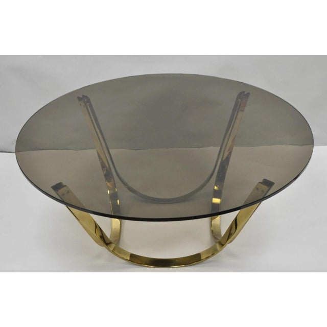 Vintage Tri-Mark Mid Century Modern Heavy Brass Plated Steel Round Smoked Glass "Arch" Coffee Table. Circa Mid 20th...