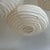 Medium-sized, oval, flattened pendant light in Japanese-style rattan and natural linen. Beautifully handcrafted: natural...