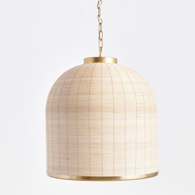 Woven in a natural cane rattan, with subtle variations in color making each one truly unique, this pendant is an instant...