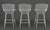 Set of Three Harry Bertoia White Patinated Wire Bar Stools, with gray leather cushions. 39" H x 21" W x 19" D; seat: 28.5"...