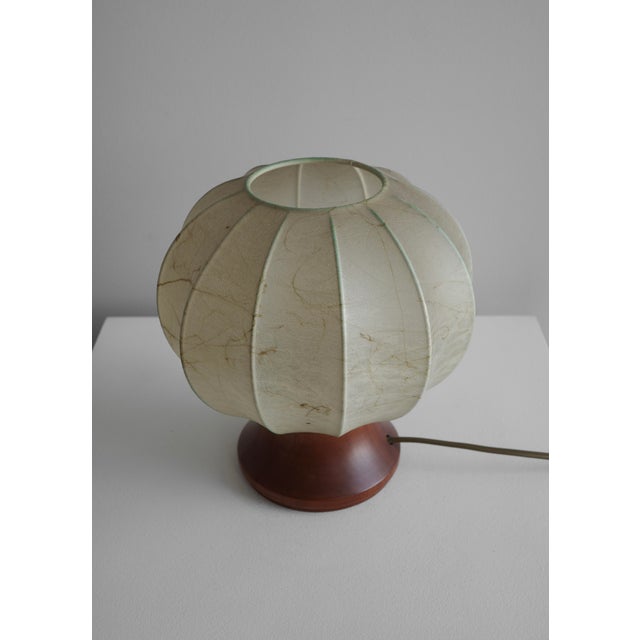 Beautiful mid-century table lamp designed by Achille Castiglioni, made in Italy in the 1960s. It has a round oak base and...