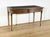 Louis XVI style mahogany veneer flat desk, with a miter-cut framed top whose edge is molded with brass strips. The center...