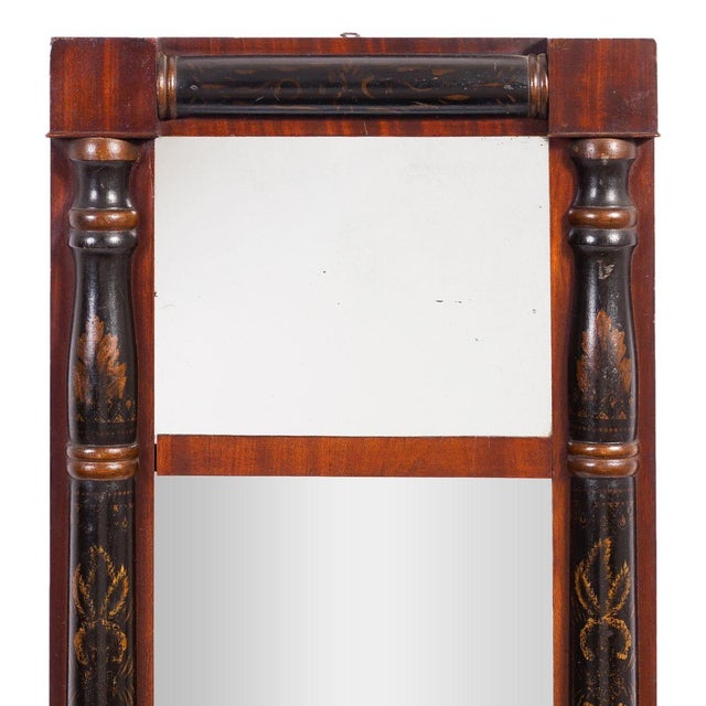 Small-scaled American Neoclassic split baluster two part mirror. The frame features ebonized half columns contrasted with...