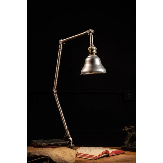 c. 1930s - 1940s; Adjustable Fixture Co. - Milwaukee, WI Steel and cast iron adjustable and articulated task lamp with...