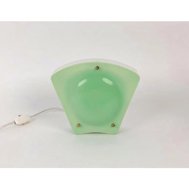 A simple, charming night light from Austria out of the 1950's. The white plastic side is meant to reflect light on the...