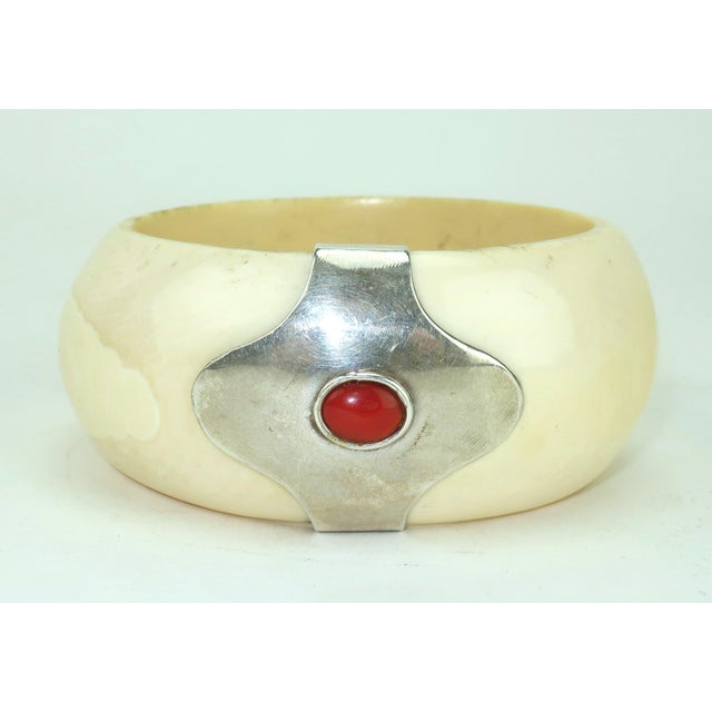 Chunky & Chic! C.1970 bone bangle bracelet embellished with a carnelian stone set in a silver frame. From an Atlanta...