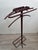 Iconic, chic, and luxurious valet stand by Jacques Adnet. France, 1950s. Tubular metal frame, entirely covered in saddle-...