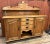 Antique country pine server with a back shelf. It has three drawers and 2 door compartments and a lower open display area....