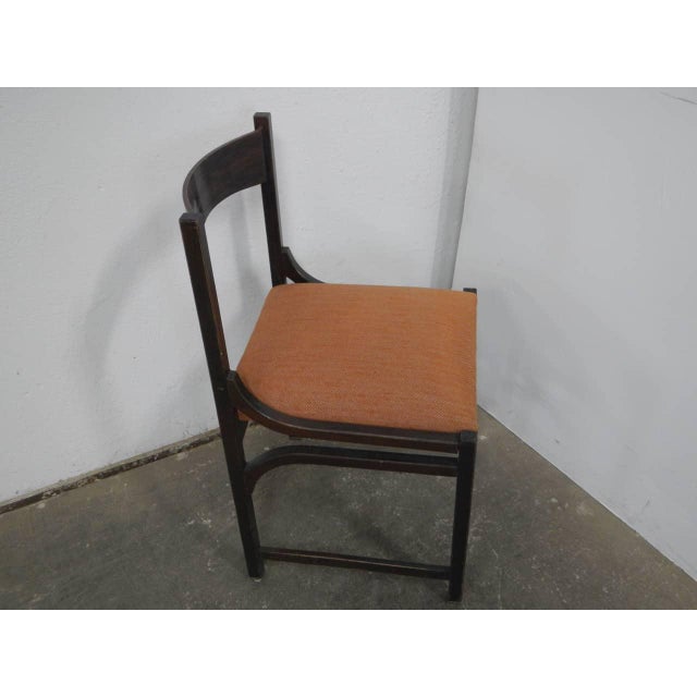 Made of brown beech wood with an orange fabric seat. Seat height 46 cm. The padding is good. Some signs of use.