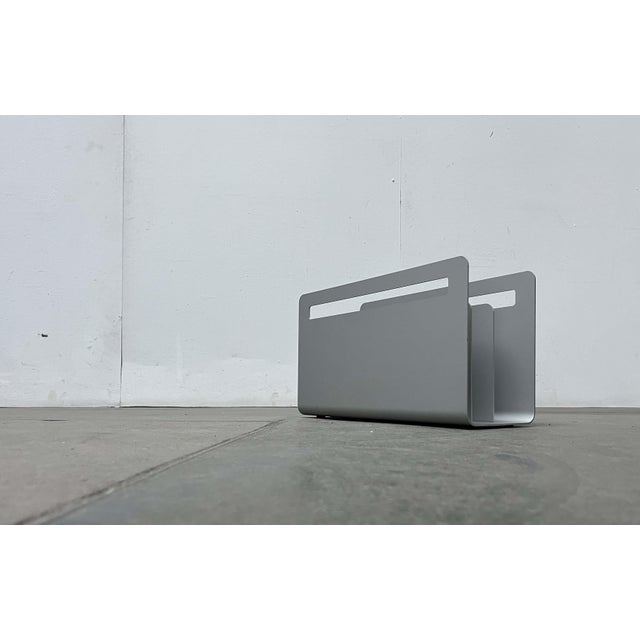 Minimalist magazine rack by Helit, designed by architect Norman Foster in the 1990s. A highly functional design. The rack...