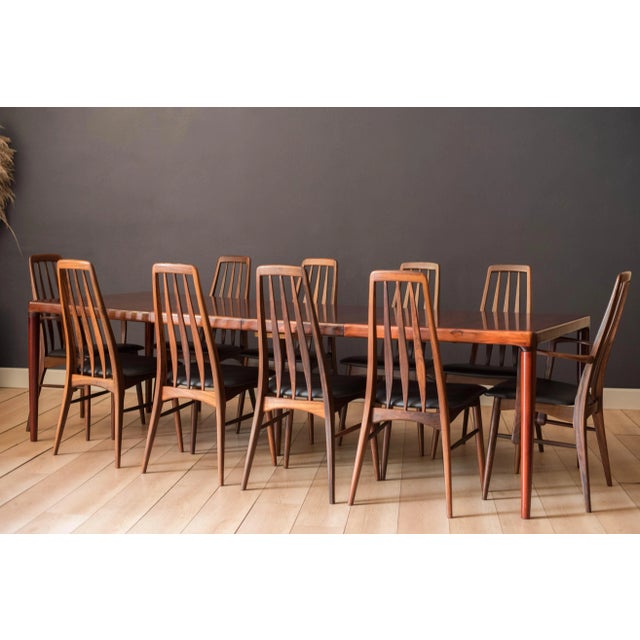 Mid Century Modern expandable dining table circa 1960's. This piece features continuous Brazilian rosewood grains and a...