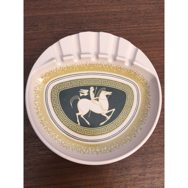 Beautiful, unused 1950's pink ashtray featuring a Greek/Roman soldier on horseback with decorative border. Has a wonderful...