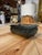 Decorative rectangular box in polished deep green marble, featuring intricate veining and subtle variations in tone. Its...