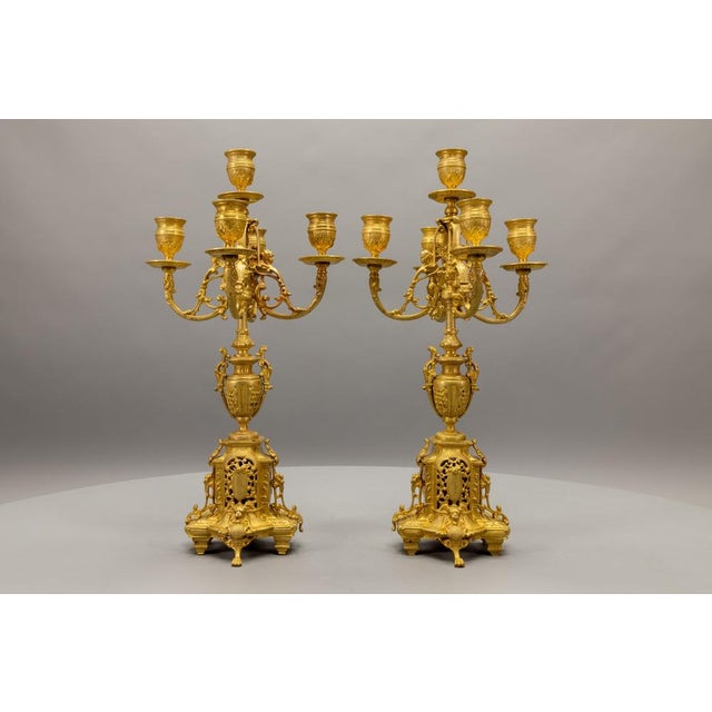 Pair of French Neoclassical bronze candelabras, circa 1920. Elegant candelabras featuring classical symmetry and refined...