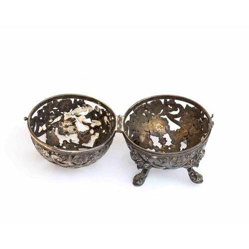 Spherical in shape, resting on four moulded feet and equipped with a hinged closure. The entire surface is perforated and...