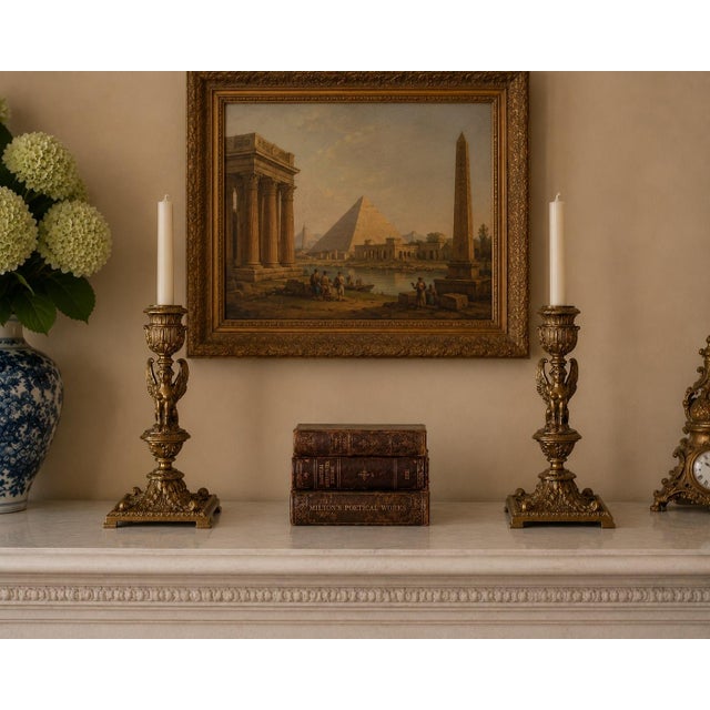 A striking matched pair of late-19th-century Egyptian Revival candlesticks cast in richly detailed gilt bronze. Each...