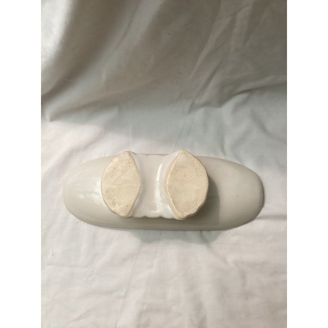 This mid-century ceramic console bowl features a long, narrow form elevated on a graceful pedestal base. Popular in the...