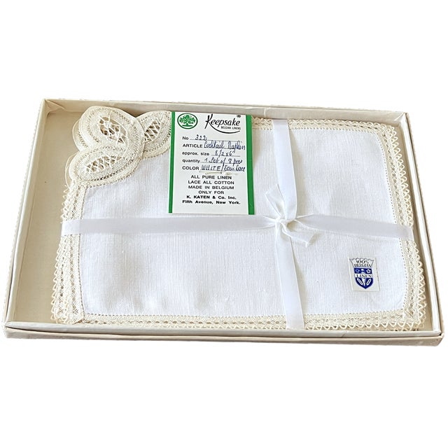A lovely boxed set of eight handmade Belgian linen cocktail napkins, circa 1950s, made for K. Katen & Co. Inc. of Fifth...