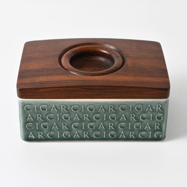 Ceramic cigar box / humidor with a heavy rosewood lid. Designed by Jens Quistgaard, made by Kronjyden in Denmark. This...