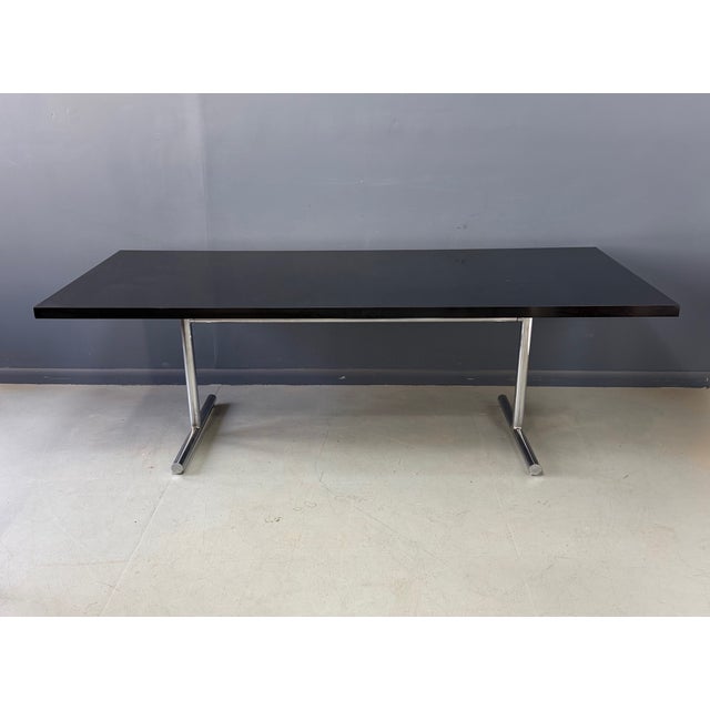 A striking and architectural Mid-Century Modern “Omega” table designed by Swiss designer Hans Eichenberger, known for his...