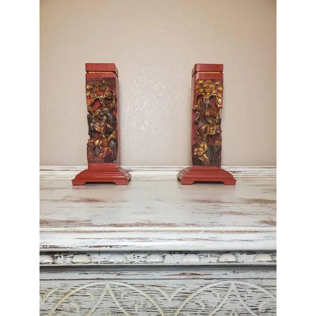 A wonderful pair of antique Chinese red lacquer and gilt gold painted hand carved wooden figural architectural elements...