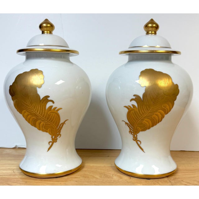 Pair of Maison Jansen–Style Porcelaine de Paris Covered Urns with Gilt Feather Decoration, France, c. 1940–1960 The set...