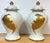 Pair of Maison Jansen–Style Porcelaine de Paris Covered Urns with Gilt Feather Decoration, France, c. 1940–1960 The set...