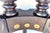This piece features a sculptural base with carved lion-paw feet, turned columns, and a distinctive architectural...