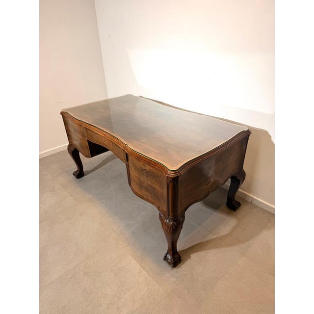This elegant antique partner’s desk is crafted in beautifully figured burr walnut veneer and features graceful serpentine...
