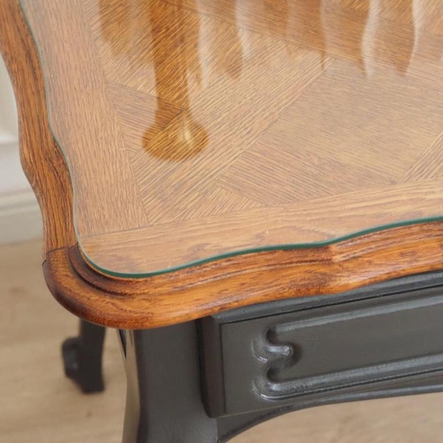 A louis xv-style desk, crafted around 1950 based on the french bureau plat model. The curved cabriole legs, the flowing...