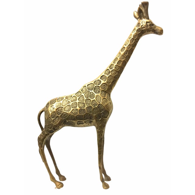 Lovely vintage giraffe figurine. This piece constructed of brass features beautiful detail in a lightly patina gold tone.