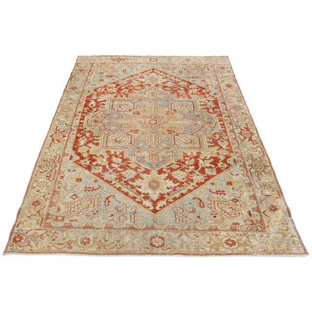 This antique Persian Heriz wool rug features a mesmerizing blue and beige motif, elegantly accentuated against a rich,...
