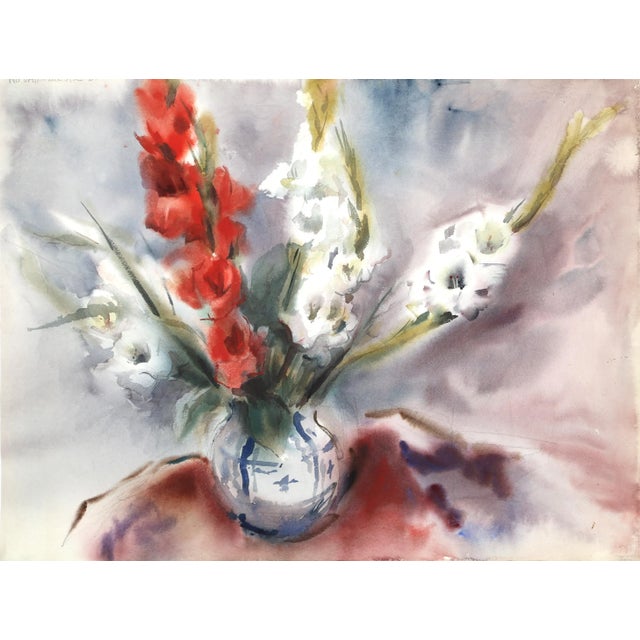This cropped still life focuses on a simple and elegant floral arrangement featuring several coned flowers in red and...