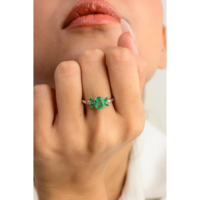 This is part of Chairish’s Fine Jewelry assortment. Natural Oval Emerald and Diamond Wedding Ring for Women in 14K Gold...