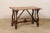 A Spanish walnut wood table with lyre legs from the 19th century. This antique table from Spain features a rectangular-...