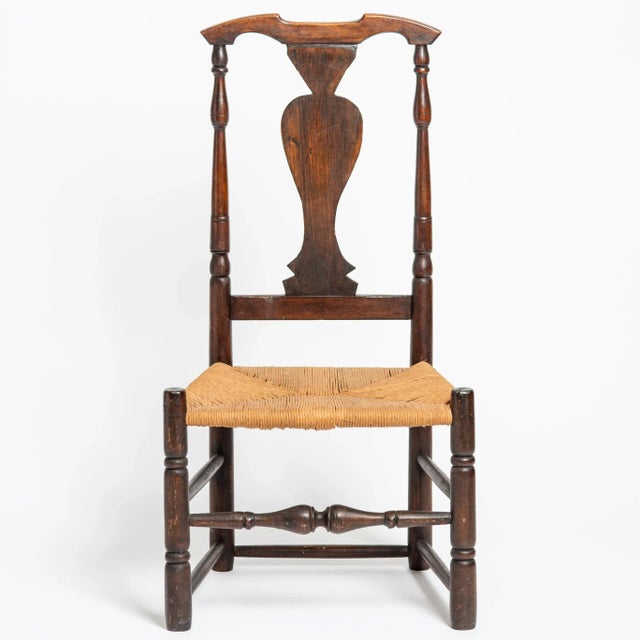 A lovely antique rush seat chair with a flat-urn-form back. The chair has nice turnings on the legs, back and front...