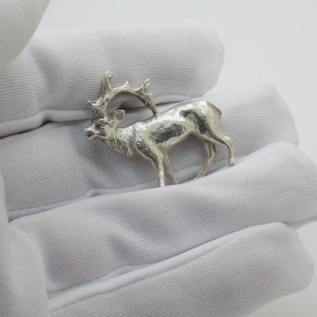 A vintage object depicting a miniature deer, crafted in Milan, Italy between the 1950s and 1960s in silver. The figure...