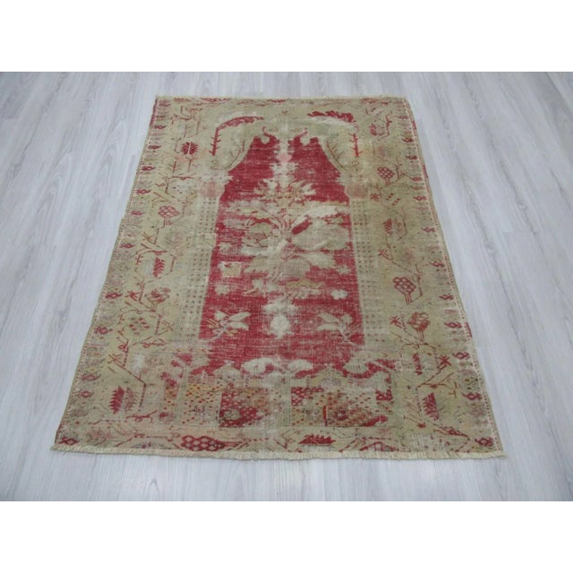 Vintage distressed rug from the Oushak region of Turkey. Approximately 50-60 years old. In good condition.