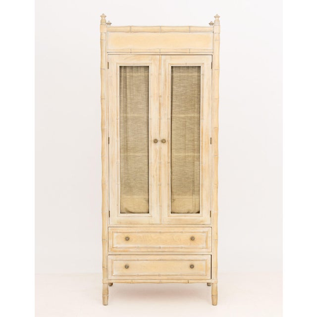 Vintage Distressed Faux Bamboo Armoire, the two cabinet doors with linen curtains opening to three shelves above two...