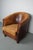 This cognac-colored leather club chair comes from the Netherlands. It is upholstered with cognac-colored leather and...