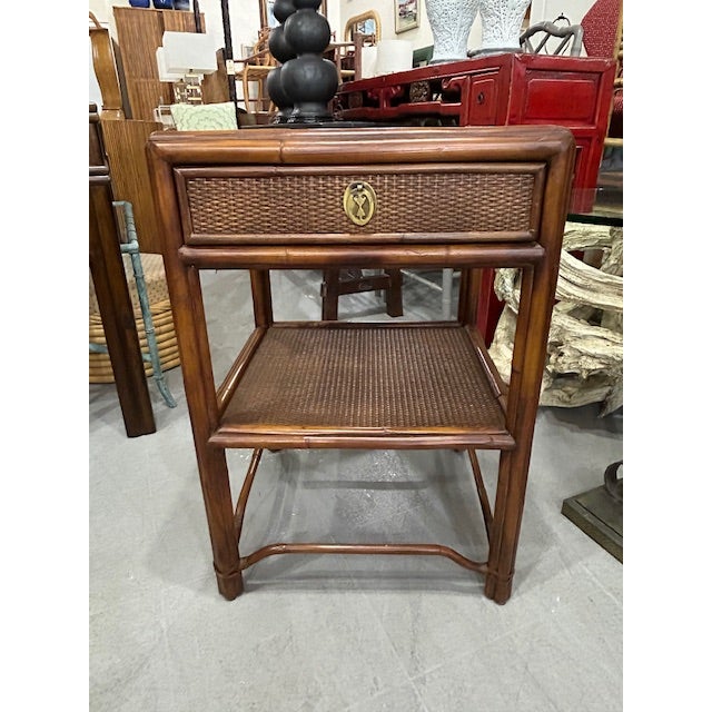 20th Century British Colonial style cane rattan side table nightstand to mix into your space. Made exclusively for...